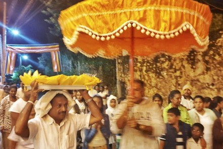 Pathi holding aloft the katina cheevaraya (robe) during the early morning perahera for the Katina Pinkama ceremony, Kandy, Sri Lanka