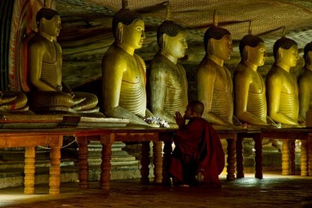 Monk at prayer in Cave II, Dambulla, Sri Lanka