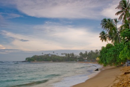 Attractive bay with golden sandy beach and waves for surfing, Unawatuna, Sri Lanka