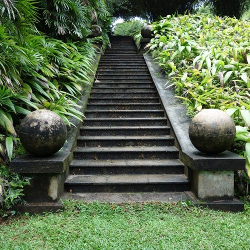 Ornate staircase and verdant foliage, Brief Garden, Bentota, Sri Lanka