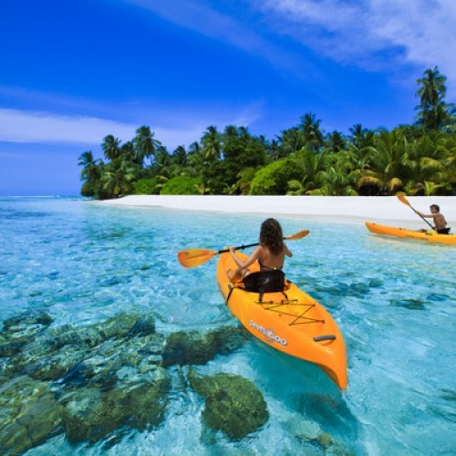 Sea kayaking in calm waters surrounding Angsana Velavaru, Maldives