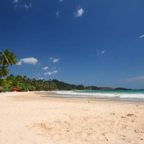 Blue sky and sandy beach near Paradise Beach Club, Mirissa, Sri Lanka