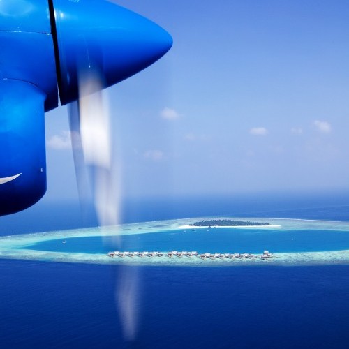 Seaplane overflying a typical atoll, Maldives