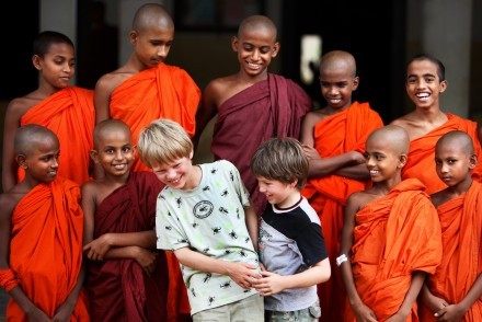 A visiting family made welcome at a Buddhist monastery, Sri Lanka