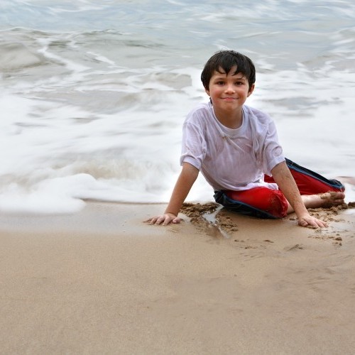 One of the boys of a family on the beach, Sri Lanka